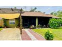 House exterior with a pergola and brick walkway at 18085 Wintergarden Ave, Port Charlotte, FL 33948