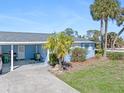 Light blue single story home with carport and palm trees at 1956 Wyoming Ave # 0, Englewood, FL 34224