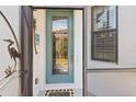 Attractive front door with leaded glass and a decorative heron on the security door at 2860 Arugula Dr, North Port, FL 34289