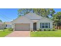 Craftsman style home with a taupe garage door and green shutters at 3924 Candia Ave, North Port, FL 34286