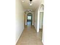 Bright hallway with tile flooring and arched doorways leading to other rooms at 3924 Candia Ave, North Port, FL 34286