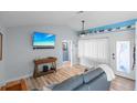 Living room with gray couch and large TV at 4338 Shappell St, Port Charlotte, FL 33948