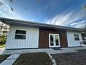 Contemporary home with white and brown siding, and a walkway at 489 & 497 Campbell St, Port Charlotte, FL 33953