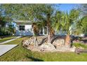 Modern house with white and wood siding, landscaping, and palm trees at 489 & 497 Campbell St, Port Charlotte, FL 33953