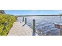 Private wooden dock extending into a calm waterway at 5189 Collingswood Blvd, Port Charlotte, FL 33948