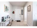 Bright and airy entryway with tile floors and coat rack at 5277 Shell Mound Cir, Punta Gorda, FL 33982