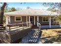 Ranch-style home with a large deck and stone walkway at 5301 Sabal Palm Ln, Punta Gorda, FL 33982