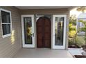 The front entrance is adorned with decorative stained glass panels on each side of the door at 6671 Keystone Ct, North Port, FL 34287