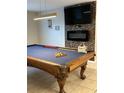 Game room featuring a pool table, fireplace, and large TV at 136 Godfrey Ne Ave, Port Charlotte, FL 33952