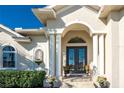 Elegant entryway with double doors and ornate columns at 1454 Surfbird Ct, Punta Gorda, FL 33950