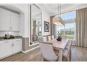 Elegant dining room featuring a large table, chandelier, and large windows at 15100 River Birch Ct, Punta Gorda, FL 33955