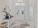 Bright and airy entryway with a stylish console table and rug at 17138 Anthem Ln, Punta Gorda, FL 33955