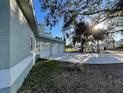 House exterior with three-car garage and trees at 18506 Klingler Cir, Port Charlotte, FL 33948