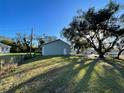 House exterior, side view with large oak tree at 18506 Klingler Cir, Port Charlotte, FL 33948