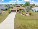 Aerial view of home with a long driveway, landscaping, and well maintained lawn at 2149 Rio De Janeiro Ave, Punta Gorda, FL 33983