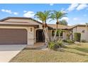 Exterior view of home with desert landscaping, a long driveway, and a two car garage at 2149 Rio De Janeiro Ave, Punta Gorda, FL 33983