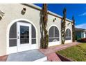 Front entrance with arched windows and a screened porch at 22498 Westchester Blvd, Punta Gorda, FL 33980