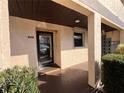 Condo entrance with door and surrounding landscaping at 2395 Harbor Blvd # 117B, Port Charlotte, FL 33952