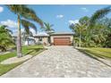 Beautiful home with paver driveway and tropical landscaping at 316 Antis Dr, Rotonda West, FL 33947