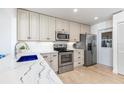 Renovated kitchen with stainless steel appliances and white cabinets at 604 Foxwood Blvd, Englewood, FL 34223