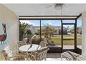 Bright sunroom with table and chairs, overlooking garden at 6796 Gasparilla Pines Blvd # 77, Englewood, FL 34224