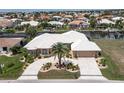 Aerial view of waterfront home with large lot and circular driveway at 920 Via Tripoli, Punta Gorda, FL 33950