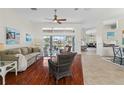 Spacious living room with hardwood floors, wicker furniture, and water views at 920 Via Tripoli, Punta Gorda, FL 33950