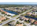 Aerial view of a community featuring many houses and waterways at 1207 Highland Greens Dr, Venice, FL 34285