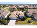 Aerial view of a beautiful home community with houses, palm trees, and canals at 1207 Highland Greens Dr, Venice, FL 34285