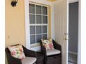 Close-up of covered front porch with decor and seating area at 1235 Saxony Cir # 5105, Punta Gorda, FL 33983