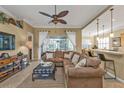 Spacious living room with L-shaped sectional sofa and open floor plan at 13298 Scrub Jay Ct, Port Charlotte, FL 33953