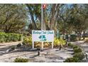 Heritage Oak Park entrance sign with landscaping and flagpole at 1577 Red Oak Ln, Port Charlotte, FL 33948