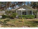 House exterior with a covered porch, landscaping, and fire hydrant at 1577 Red Oak Ln, Port Charlotte, FL 33948