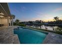 Relaxing outdoor pool area overlooking a scenic waterfront view, perfect for enjoying the coastal lifestyle at 183 Maria Ct, Punta Gorda, FL 33950