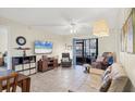 Bright living room with tiled floors and comfy furniture at 19505 Quesada Ave # Jj101, Port Charlotte, FL 33948