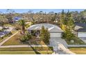 Single-story house with a gray roof, white garage door, and surrounding neighborhood visible at 2202 Gold Oak Ln, Sarasota, FL 34232