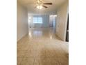 Bright and airy living room with tile flooring and ceiling fan at 2461 Ivanhoe St, Port Charlotte, FL 33952