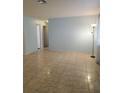 Spacious living room featuring light blue walls and tile flooring at 2461 Ivanhoe St, Port Charlotte, FL 33952