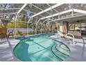 Inviting kidney-shaped pool with screened enclosure at 3189 Tally Ho Rd, North Port, FL 34291