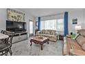 Living room with light colored floors and couches at 407 Dunn Ne Dr, Port Charlotte, FL 33952