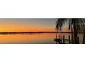 Peaceful sunset view over calm water with a dock at 422 Omen St, Punta Gorda, FL 33982