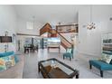 Bright living room with high ceilings, hardwood floors, and a large window at 4630 Fallon Cir, Port Charlotte, FL 33948