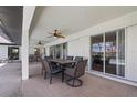Covered patio with table and chairs, adjacent to the pool at 4630 Fallon Cir, Port Charlotte, FL 33948