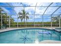 Inviting pool with a spa and screened enclosure overlooking a canal at 5028 San Massimo Dr, Punta Gorda, FL 33950