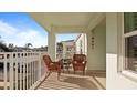 Condo balcony with wicker chairs and table at 5725 Greenwood Ave # 7203, North Port, FL 34287