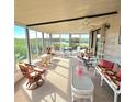 Bright sunroom with water views and wicker furniture at 735 Blackburn Blvd, North Port, FL 34287