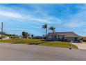 Tan single-Gathering home with palm trees and driveway at 7352 Parkinsonia, Punta Gorda, FL 33955