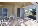 Relaxing screened porch with patio furniture and view of yard at 7352 Parkinsonia, Punta Gorda, FL 33955