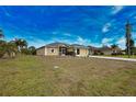 One-story house with landscaped yard and driveway at 110 Albatross Rd, Rotonda West, FL 33947
