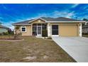 Tan house with gray roof, screened porch, and two-car garage at 110 Albatross Rd, Rotonda West, FL 33947